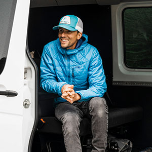 Photographer Justin Myers sitting in a sprinter van