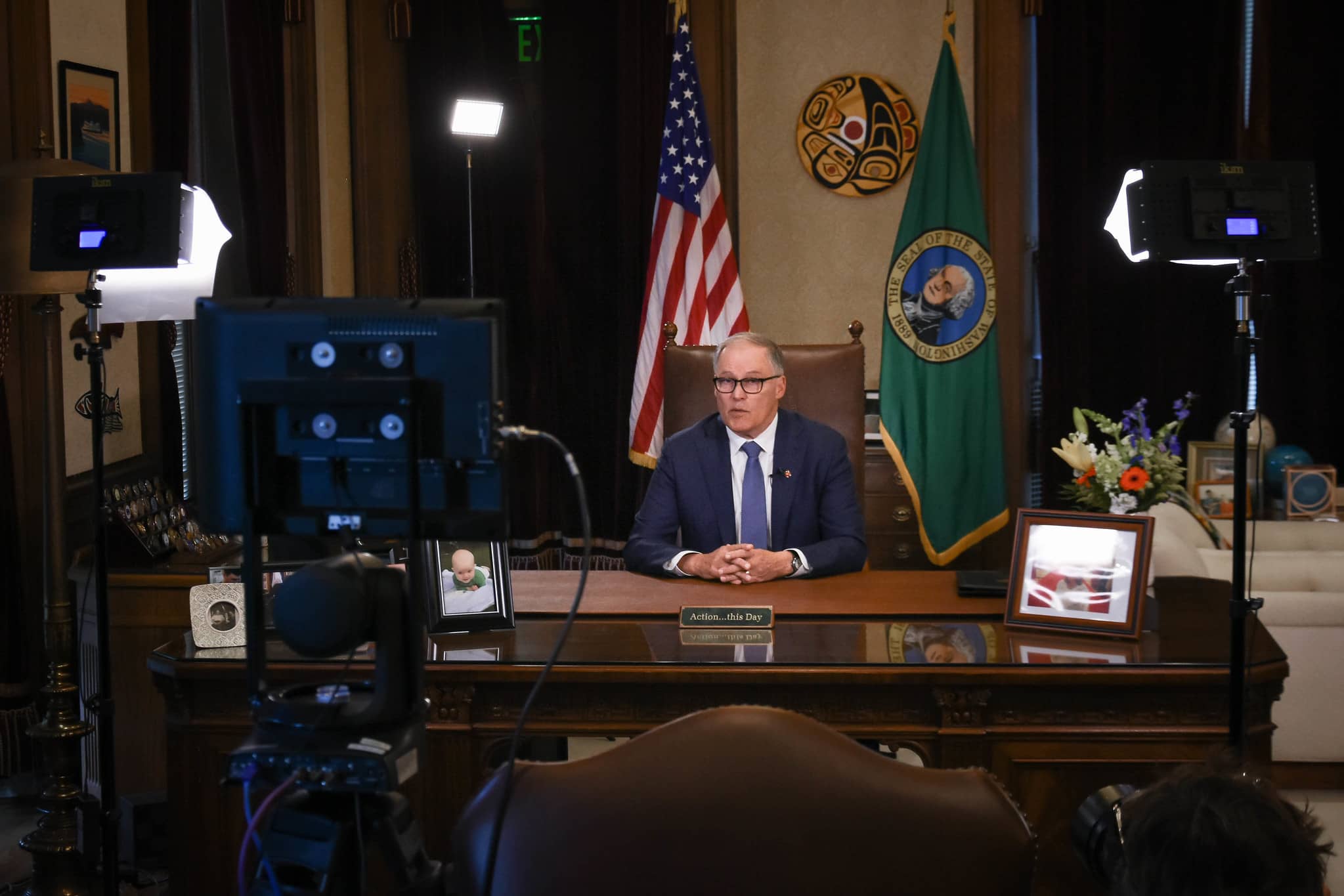 Washington Governor Jay Inslee addressing citizens from his office during the Covid-19 pandemic