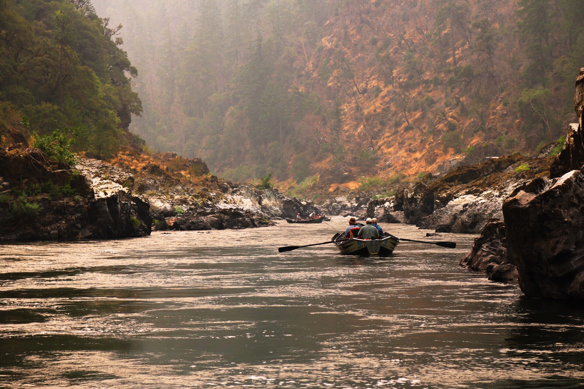 Floating and fishing in a drift boat through a smoke filled canyon on Oregon's wild and scenic Rogue River. The beginning of the Wild Human story.