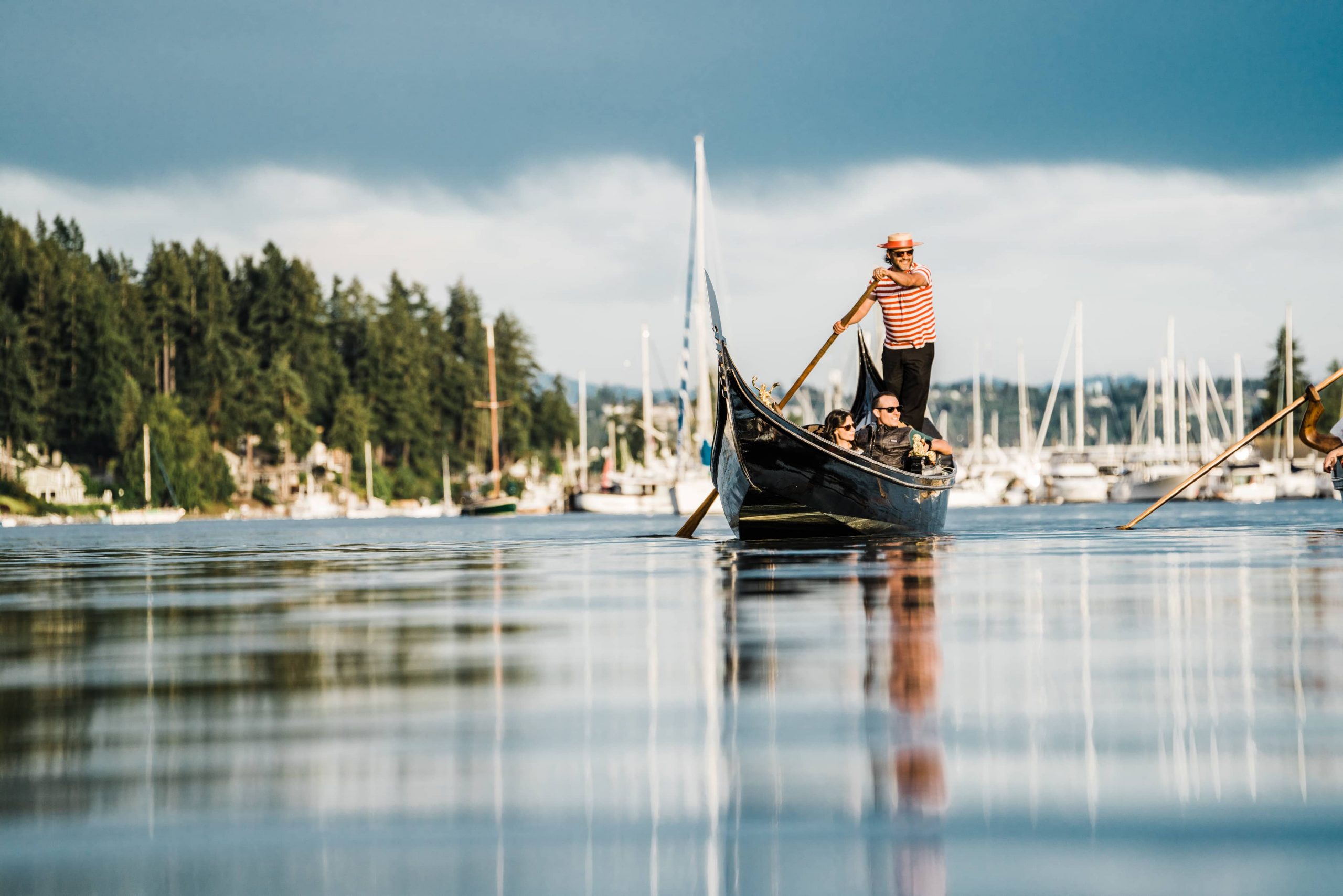 A gondola rowing through Gig Harbor with a dark sky in the background