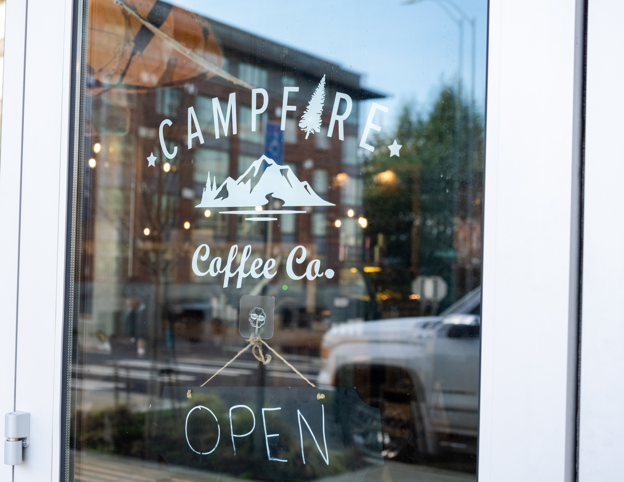 A glass door with the Campfire Coffee logo