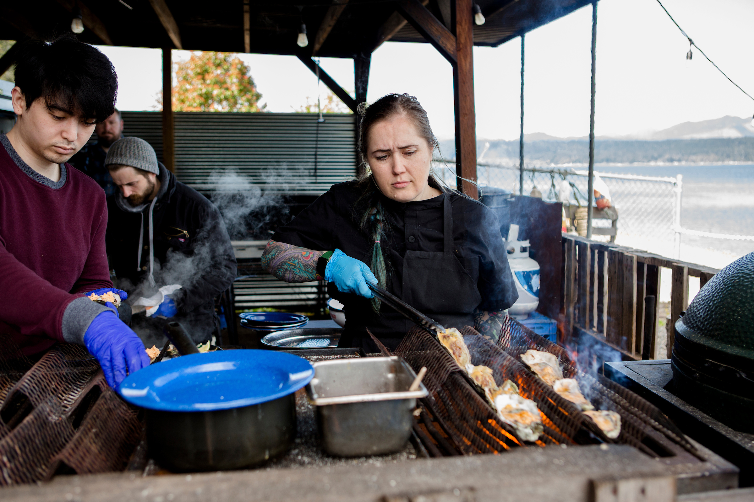 Executive Chef Sara Harvey cooking oysters over an open fire at Hook & Fork eatery in Union, Washington