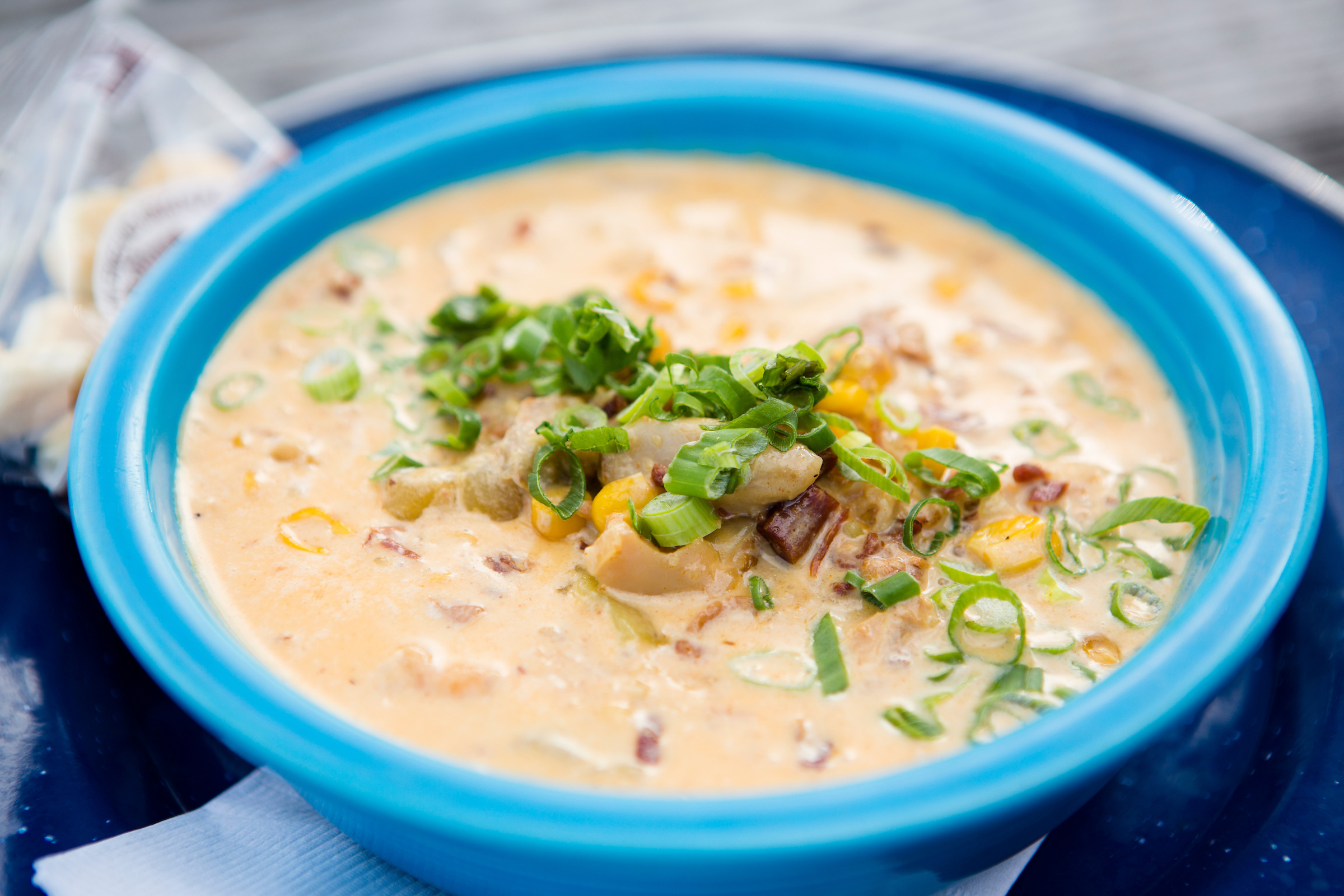 A bowl of corn chowder topped with green onions