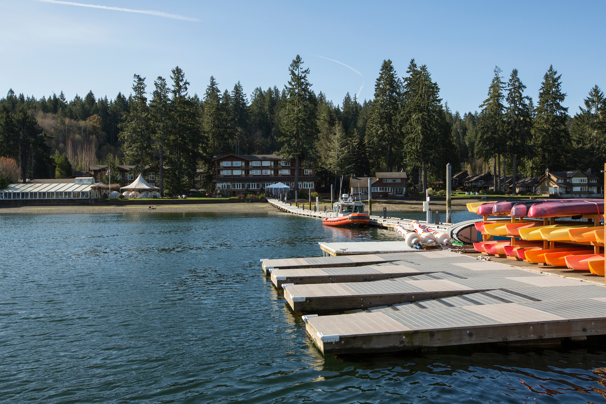 The dock of the Alderbrook Resort & Spa lined with kayaks and stand up paddle boards