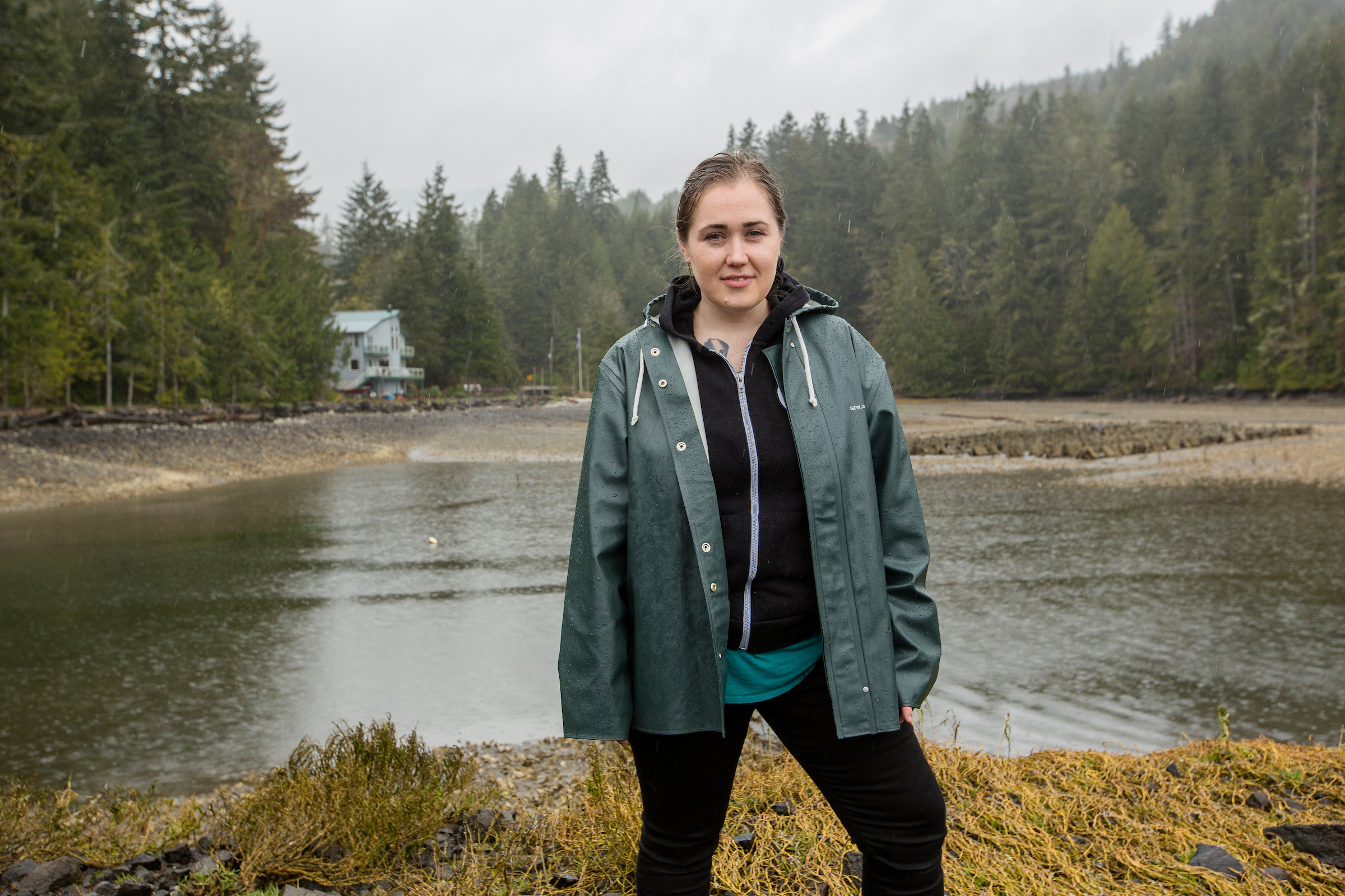 A portrait of Alderbrook Resort & Spa's executive chef, Sara Harvey in the cove where she keeps her oyster farm
