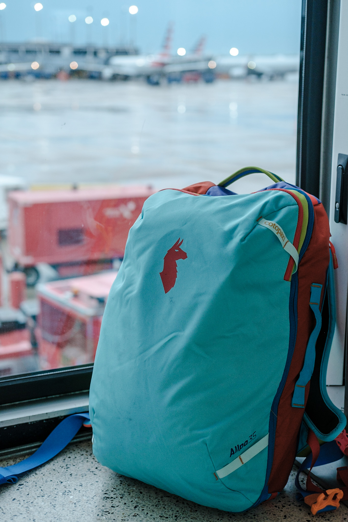 Cotopaxi Allpa 35L fully loaded in an airport terminal