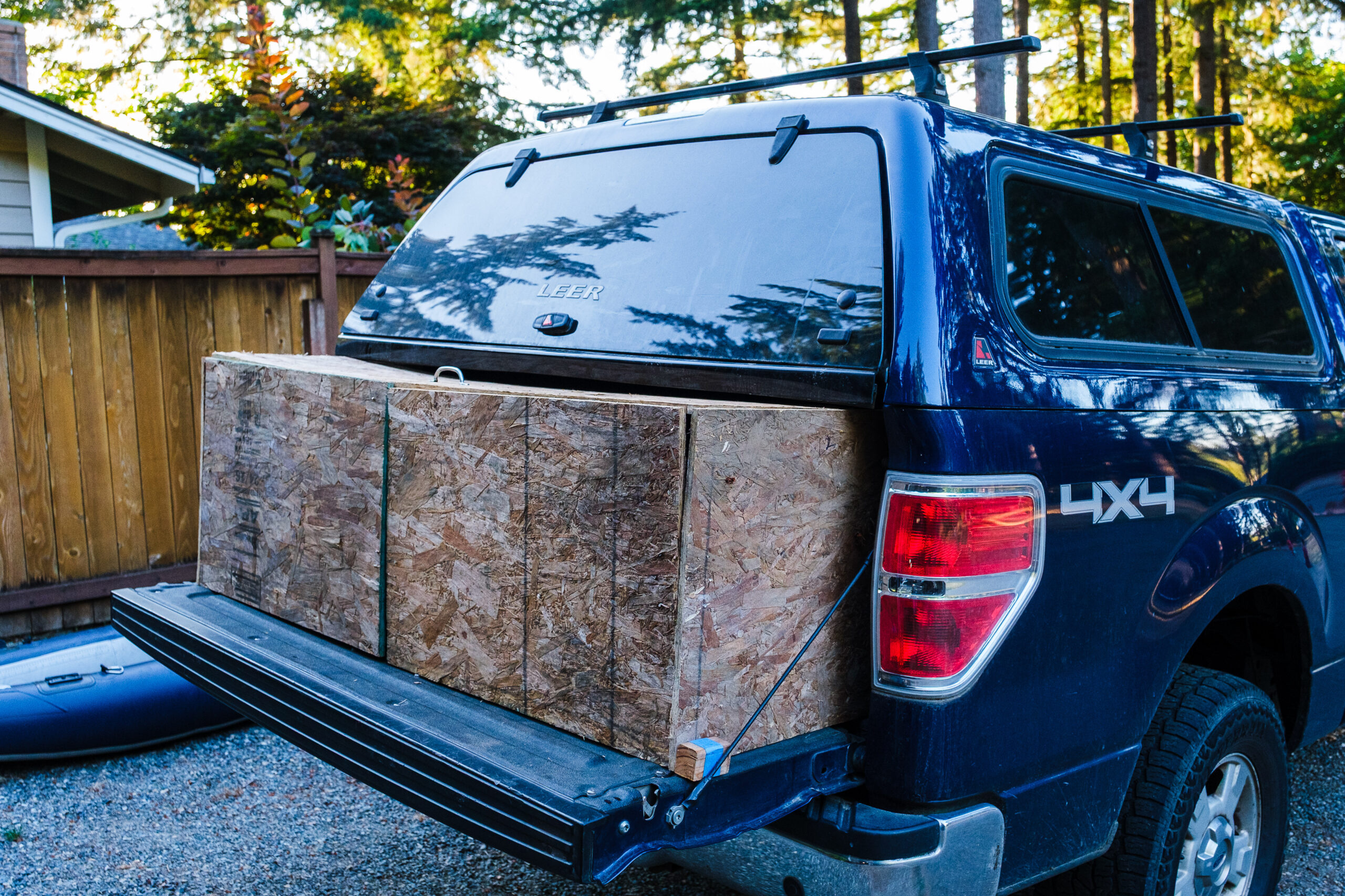 A box made of wood OSB boards on an open truck tailgate