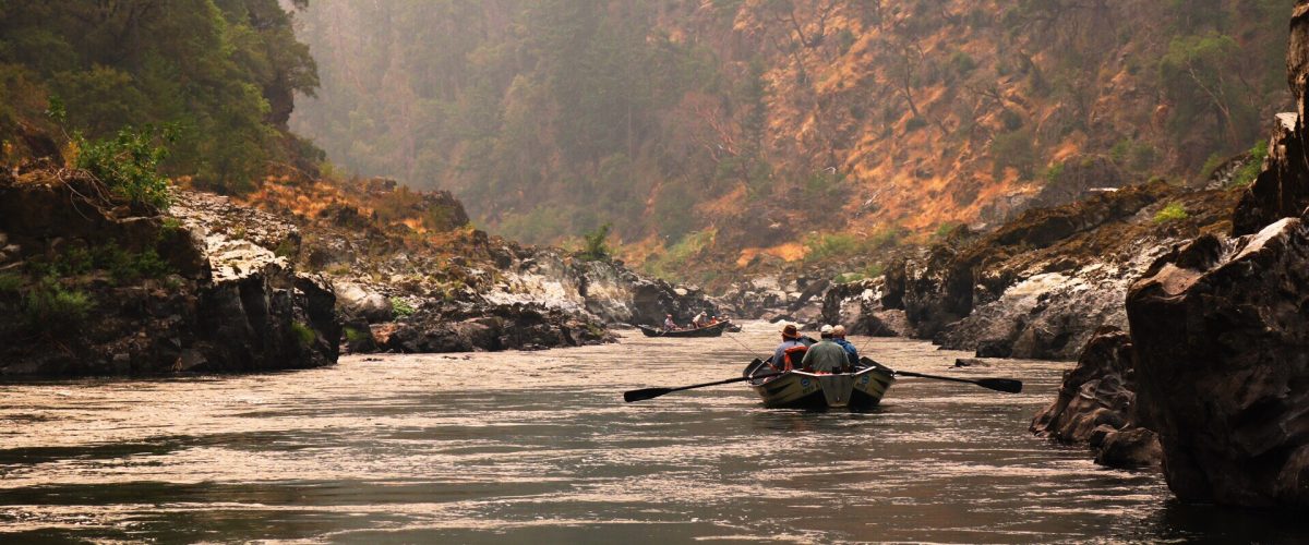 Floating and fishing in a drift boat through a smoke filled canyon on Oregon's wild and scenic Rogue River. The beginning of the Wild Human story.
